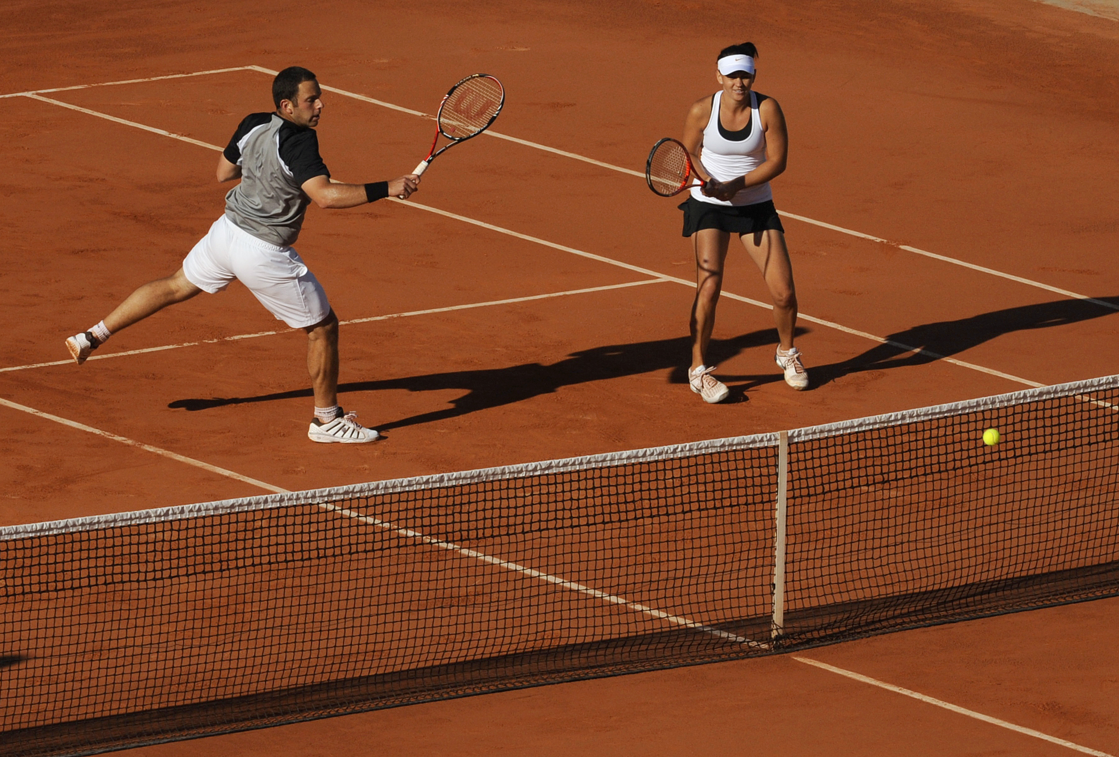 Australia's Casey Dellacqua (R) and Serb