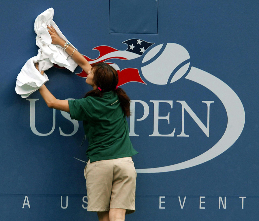 A court attendant cleans off the wall on
