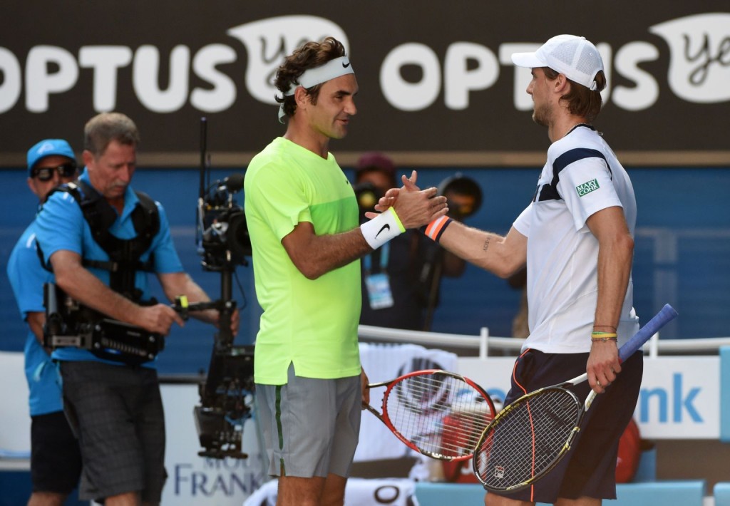 Italy's Andreas Seppi (R) shakes hands as he celebrates after victory in his men's singles match against Switzerland's Roger Federer (L) on day five of the 2015 Australian Open tennis tournament in Melbourne on January 23, 2015. AFP PHOTO / MAL FAIRCLOUGH-- IMAGE RESTRICTED TO EDITORIAL USE - STRICTLY NO COMMERCIAL USE        (Photo credit should read MAL FAIRCLOUGH/AFP/Getty Images)