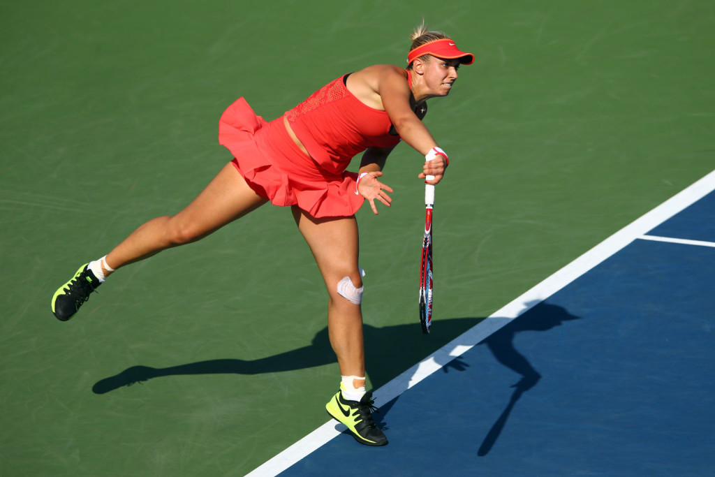 NEW YORK, NY - SEPTEMBER 07:  Sabine Lisicki of Germany serves to Simona Halep of Romania during their Women's Singles Fourth Round match on Day Eight of the 2015 US Open at the USTA Billie Jean King National Tennis Center on September 7, 2015 in the Flushing neighborhood of the Queens borough of New York City.  (Photo by Clive Brunskill/Getty Images)