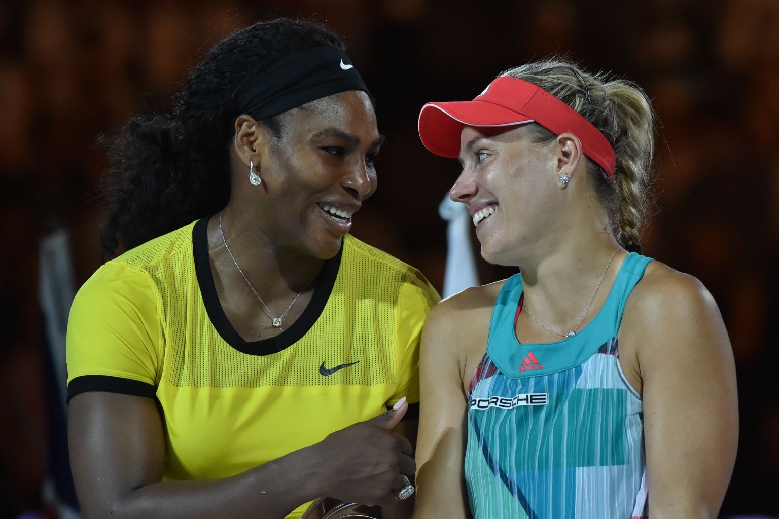 Angelique Kerber of Germany (R) is congratulated during the awards ceremony by Serena Williams of the US (L) after Kerber's victory in their women's singles final match on day 13 of the 2016 Australian Open tennis tournament in Melbourne on January 30, 2016. AFP PHOTO / PAUL CROCK -- IMAGE RESTRICTED TO EDITORIAL USE - STRICTLY NO COMMERCIAL USE / AFP / PAUL CROCK        (Photo credit should read PAUL CROCK/AFP/Getty Images)