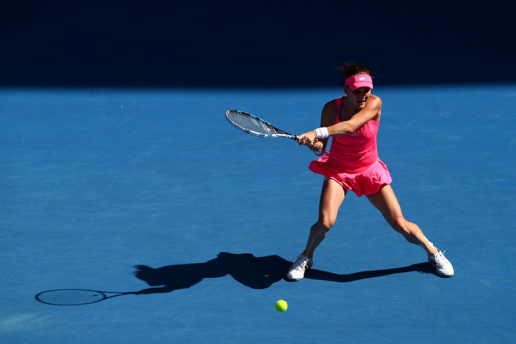 XXX of ZZZ plays a forehand in his/her first round match against XXXX of ZZZZ during day one of the 2016 Australian Open at Melbourne Park on January 18, 2016 in Melbourne, Australia.