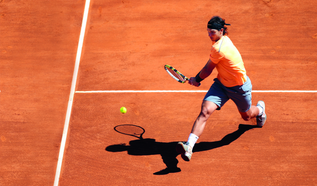 Spain's Rafael Nadal hits a return to Serbia's Novak Djokovic during the Monte-Carlo ATP Masters Series Tournament tennis final match, on April 22, 2012 in Monaco. Nadal won 6-3, 6-1.  AFP PHOTO/ VALERY HACHE (Photo credit should read VALERY HACHE/AFP/Getty Images)