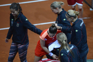 STUTTGART, GERMANY - APRIL 22:  Andrea Petkovic of Germany takes comfort of her teammates after being defeated by Samantha Stosur of Australia during day two of the Federation Cup 2012 World Group Play-Off match between Germany and Australia at Porsche Arena on April 22, 2012 in Stuttgart, Germany.  (Photo by Dennis Grombkowski/Bongarts/Getty Images)