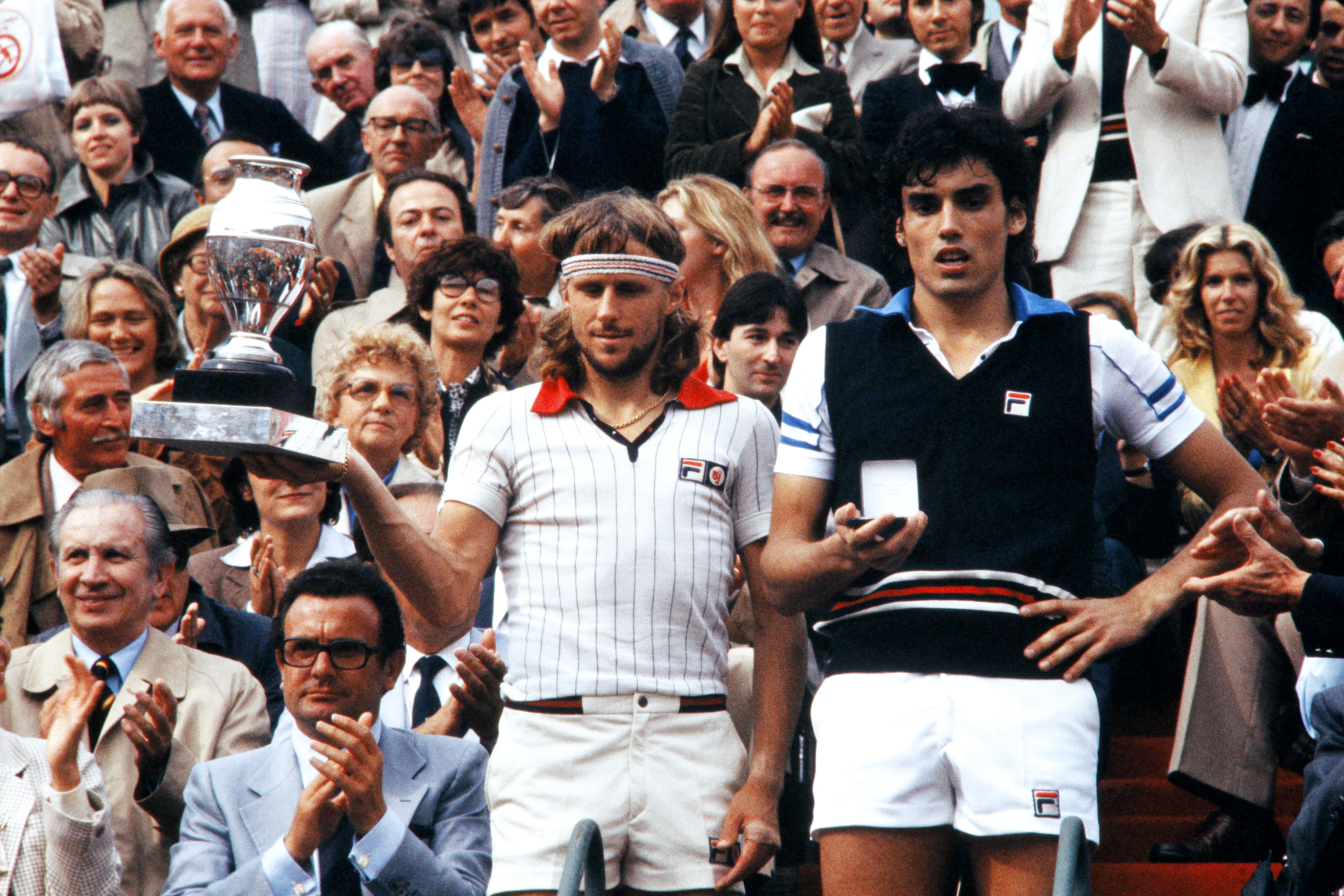 Sweden's tennis player Bjorn Borg (L) holds his trophy on June 9, 1979 after defeating Italian Victor Pecci (R) during the Men's French Open Finals at Roland Garros stadium. AFP PHOTO (Photo credit should read STAFF/AFP/Getty Images)