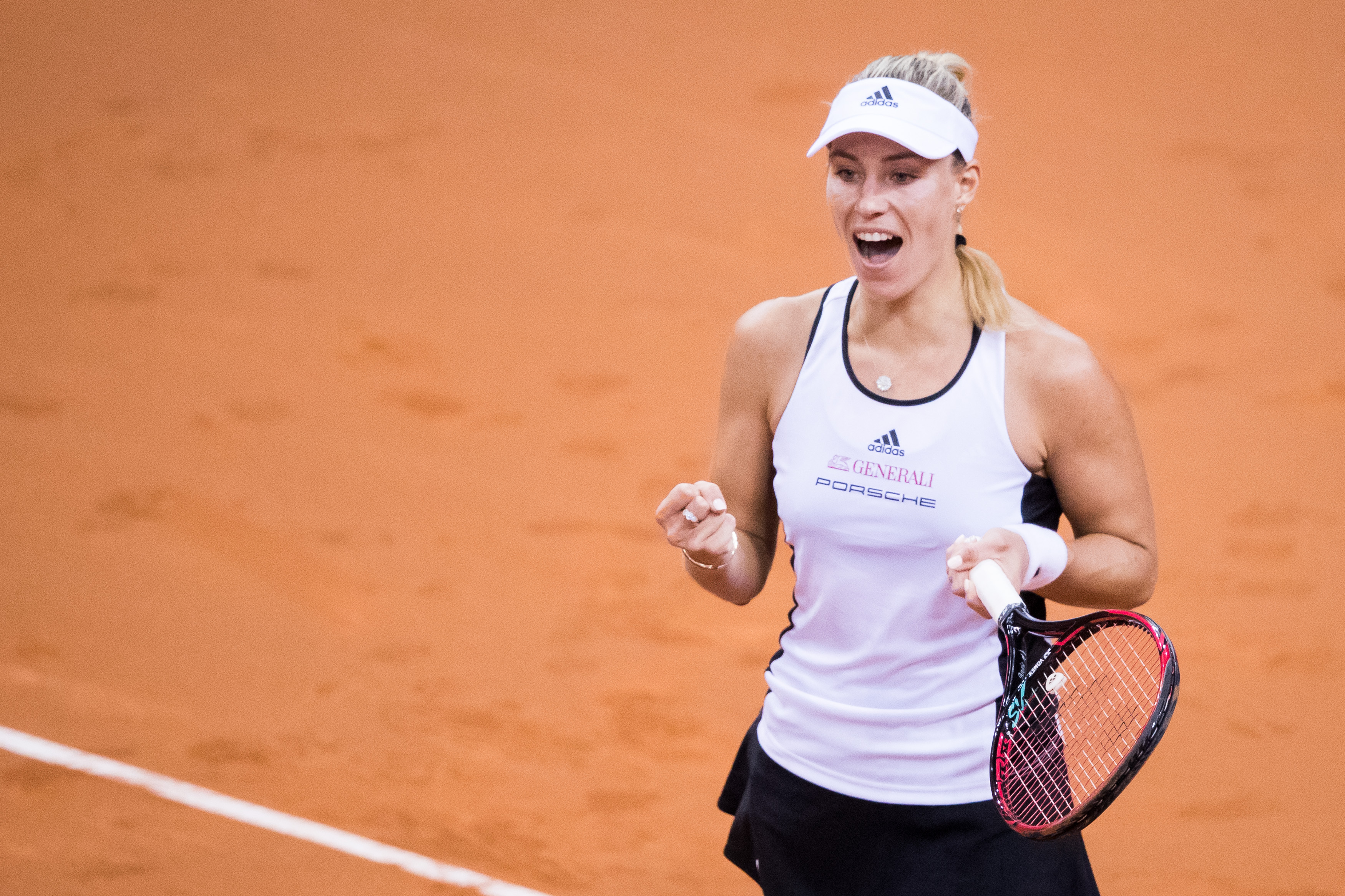 STUTTGART, GERMANY - APRIL 22: Angelique Kerber of Germany celebrates winning the match point against Lesia Tsurenko of Ukraine during the FedCup World Group Play-Off Match between Germany and Ukraine at Porsche Arena on April 22, 2017 in Stuttgart, Germany. (Photo by Simon Hofmann/Bongarts/Getty Images)