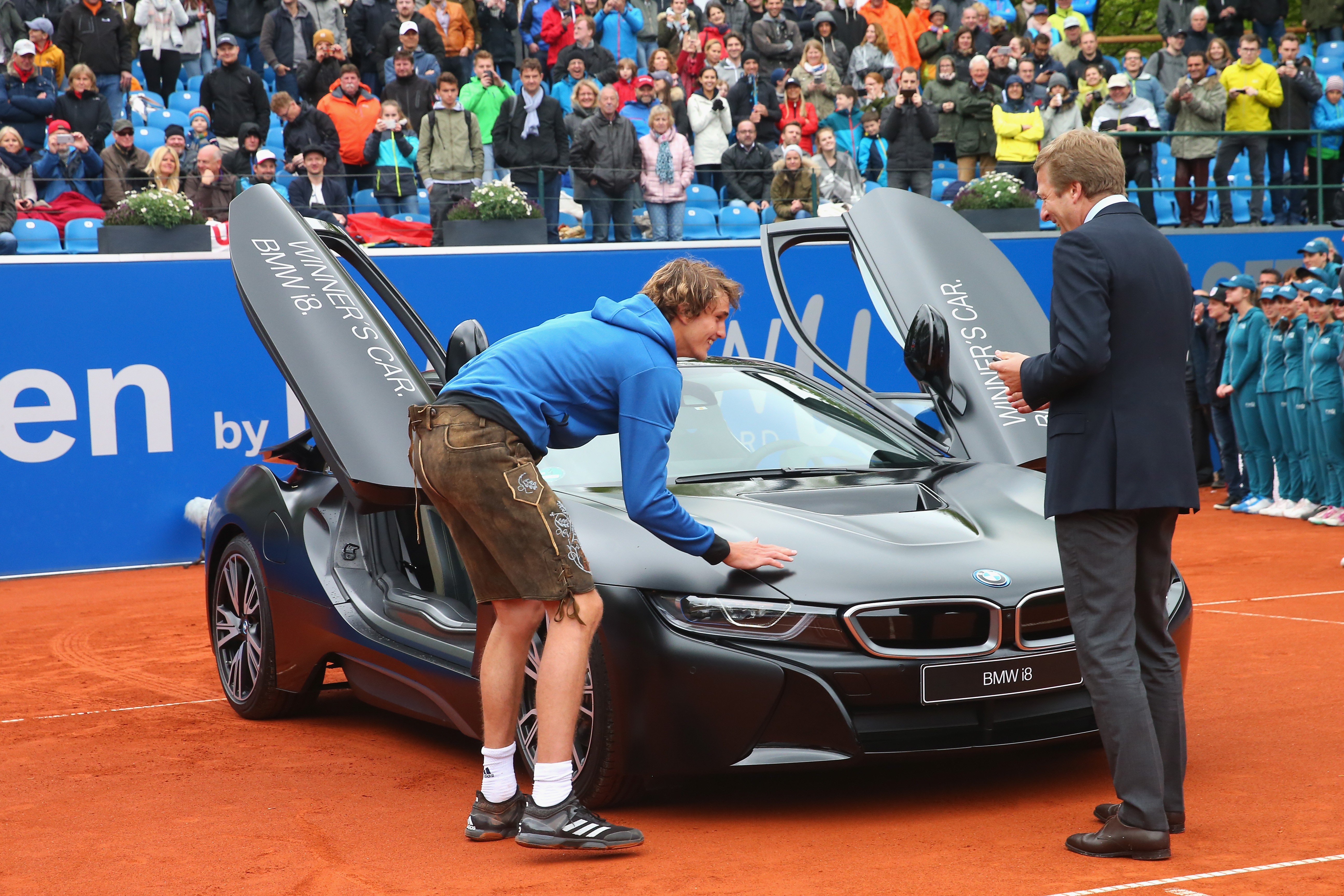 MUNICH, GERMANY - MAY 07: Alexander Zverev of Germany celebrates with winner's car BMW i8 after winning his finale match against Guido Pella of Argentina of the 102. BMW Open by FWU at Iphitos tennis club on May 7, 2017 in Munich, Germany. (Photo by Alexander Hassenstein/Getty Images For BMW)