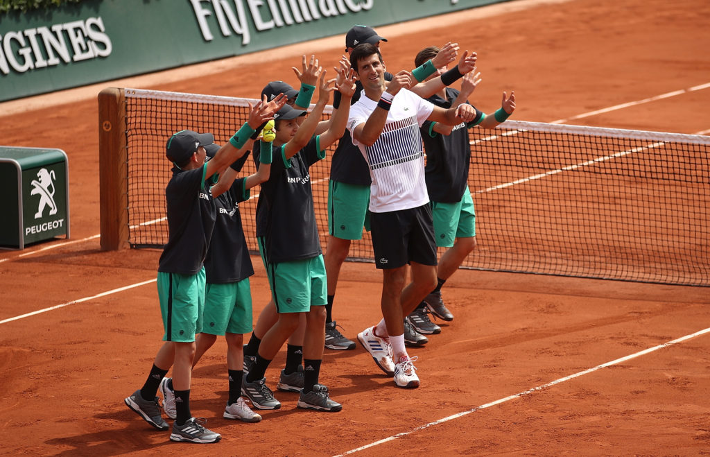 PARIS, FRANCE - MAY 29: Novak Djokovic of Serbia celebrates with the ball boys after beating Marcel Granollers of Spain in their first round match on day two of the 2017 French Open at Roland Garros on May 29, 2017 in Paris, France. (Photo by Julian Finney/Getty Images)