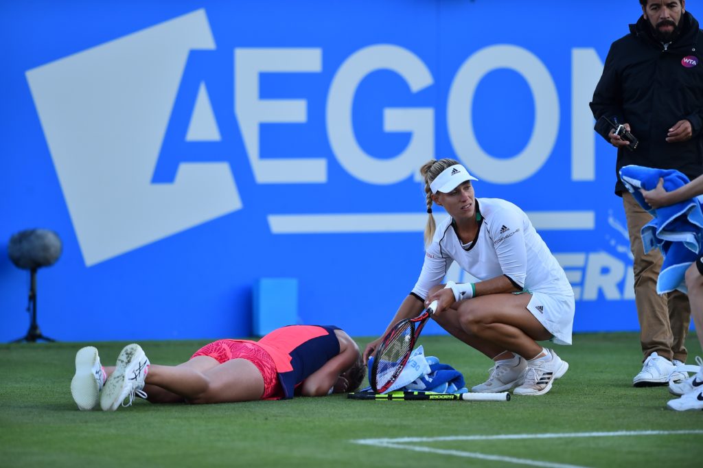 Britain's Johanna Konta (L)lies face down after slipping as Germany's Angelique Kerber looks on during their women's singles quarter-finals tennis match against at the ATP Aegon International tennis tournament in Eastbourne, southern England, on June 29, 2017. Johanna Konta beat Angelique Kerber 6-3, 6-4. / AFP PHOTO / Glyn KIRK (Photo credit should read GLYN KIRK/AFP/Getty Images)