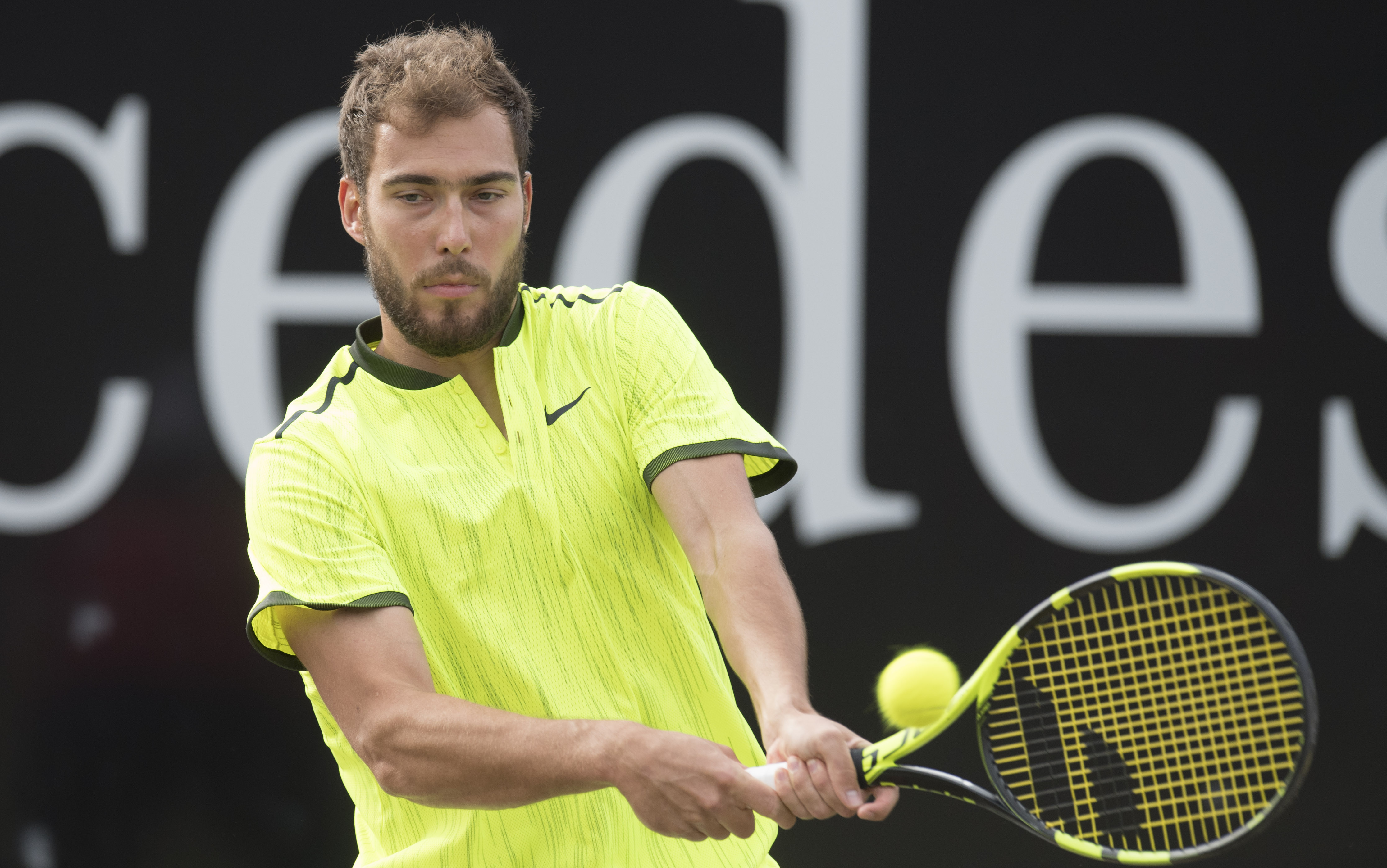 Poland's Jerzy Janowicz returns a shot to France's Benoit Paire during an ATP tennis tournament quarterfinal match in Stuttgart, southwestern Germany, on June 16, 2017.  / AFP PHOTO / THOMAS KIENZLE        (Photo credit should read THOMAS KIENZLE/AFP/Getty Images)