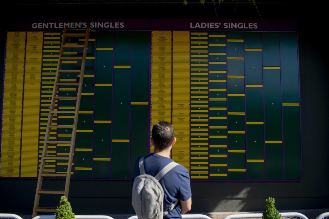 180702 An individual looks at the scoreboard during day 1 of Wimbledon on July 2 2018 in London P